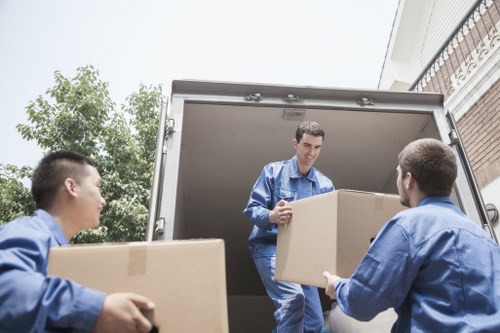 Small removals van loading boxes in Battersea