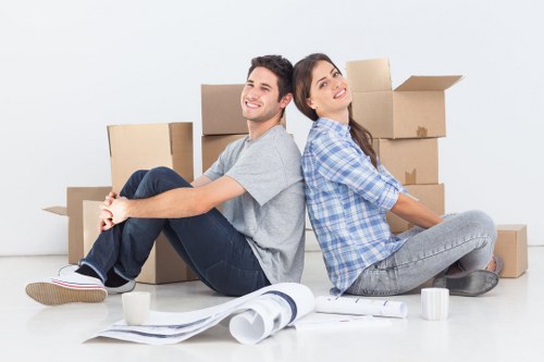 Loading office furniture into a removals vehicle in Battersea