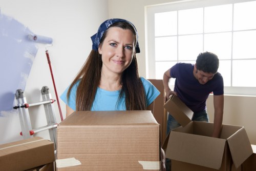 Professional movers loading household items for storage
